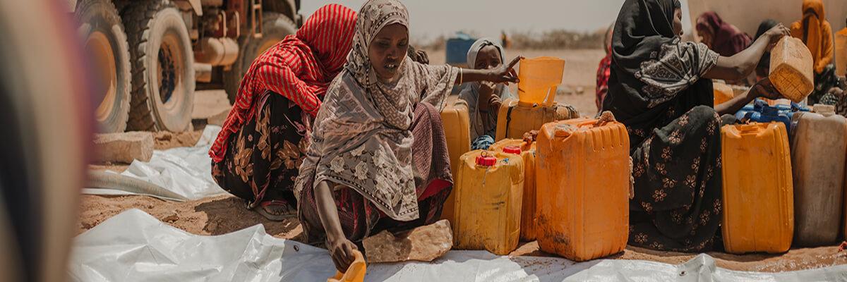 Women collecting water at a distribution point in Ethiopia.